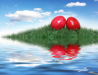 Image showing Red Easter eggs on a small hill