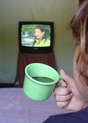 Image showing Watching TV and drinking coffee