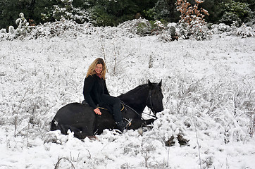 Image showing girl and horse in snow