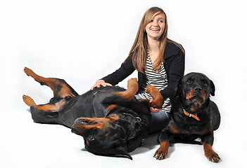 Image showing teen and rottweilers