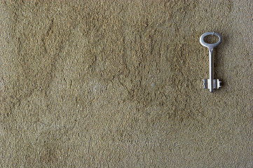 Image showing Iron key on a concrete wall 