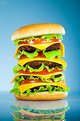 Image showing Tasty and appetizing hamburger on a blue
