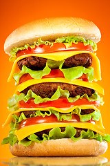 Image showing Tasty and appetizing hamburger on a yellow