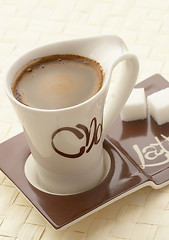 Image showing choco latte. A white cup of coffee on a support. 