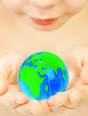 Image showing boy holds globe in hands