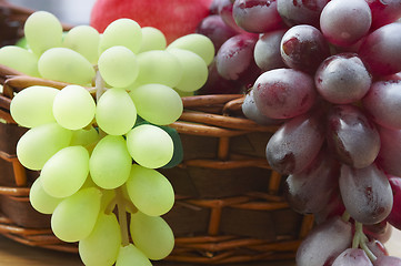 Image showing Red and white grape branch in a basket 