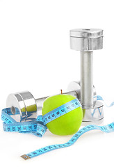 Image showing Dumbbells and apple. A healthy way of life