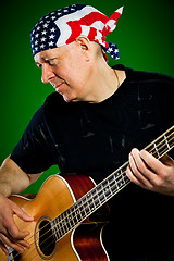 Image showing man with a guitar, bass player