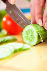 Image showing Woman's hands cutting vegetables