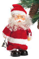 Image showing santa with a handbell in hands near a fur-tree