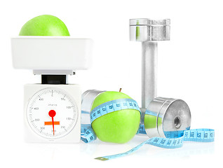 Image showing Dumbbells and apple. A healthy way of life