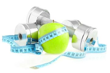 Image showing Dumbbells and apple. A healthy way of life