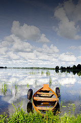 Image showing Boat moored rubber tires cloud reflection on water 