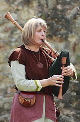 Image showing Female bagpiper