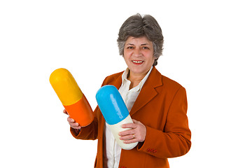 Image showing Female senior with two big size pills 