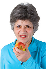 Image showing Female senior eating a fresh apple