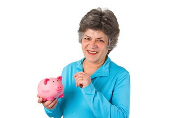 Image showing Female senior with piggy bank 