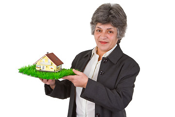 Image showing Female senior with toy house