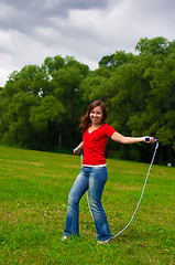 Image showing Young woman with skipping rope