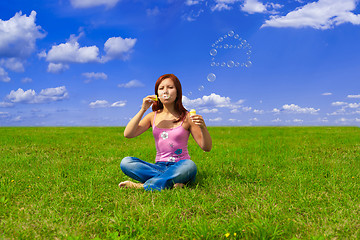 Image showing girl blowing soap bubbles