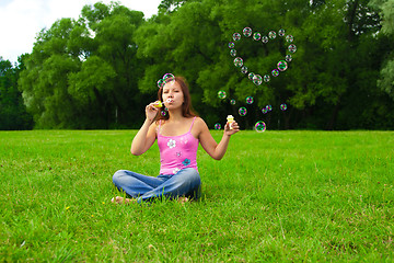 Image showing girl blowing soap bubbles