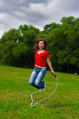 Image showing Young woman with skipping rope