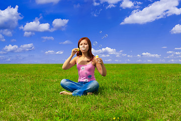 Image showing girl blowing soap bubbles