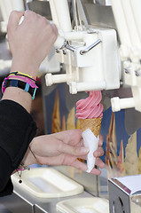 Image showing woman's hand making an italian ice cream