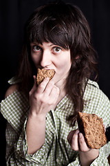 Image showing beggar woman eating bread