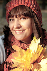 Image showing woman with autumn orange leaves