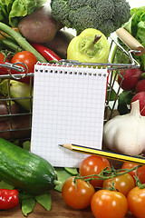 Image showing shopping list with pencil, basket and vegetables