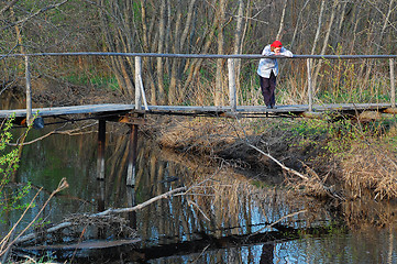 Image showing Sad Woman on Wooden Bridge in the Late Fall