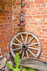 Image showing Antique wooden carriage wheel and kerosine lamp  