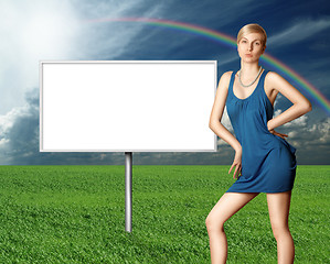 Image showing billboard and sexy blonde on green grass and blue cloudly sky