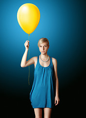 Image showing blonde in blue dress with the yellow balloon