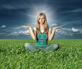 Image showing Blonde in lotus pose in green grass