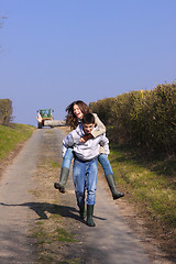 Image showing Couple of young people walking in the campaign in spring