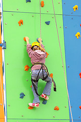 Image showing Child climbing on a climbing wall, outdoor