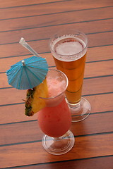 Image showing glass of fruit cocktail and a glass of beer