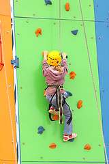 Image showing Child climbing on a climbing wall, outdoor