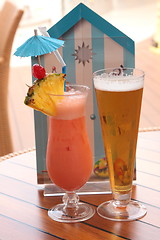 Image showing glass of fruit cocktail and a glass of beer