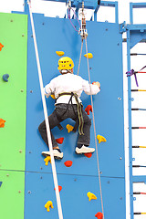 Image showing Child climbing on a climbing wall, outdoor