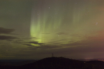 Image showing Vivid aurora borealis through clouds