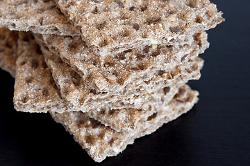 Image showing Multi-grain crisp bread on dark background