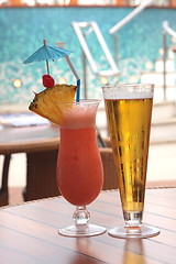 Image showing glass of fruit cocktail and a glass of beer