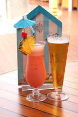 Image showing glass of fruit cocktail and a glass of beer