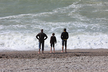 Image showing a father and his two boys watching the sea