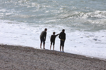 Image showing a father and his two boys watching the sea