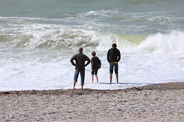 Image showing a father and his two boys watching the sea