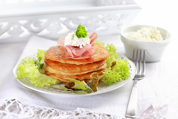 Image showing Small potato pancakes with salad